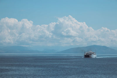 Boat sailing in sea against sky