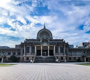 Facade of building against cloudy sky