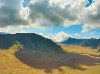 Scenic view of mountains against cloudy sky