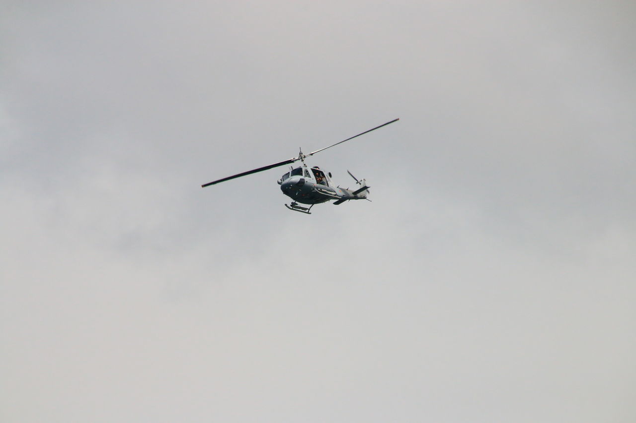 LOW ANGLE VIEW OF HELICOPTER IN SKY