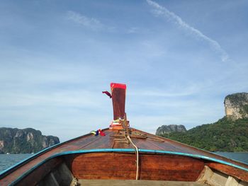 Cropped image of boat on lake against blue sky during sunny day