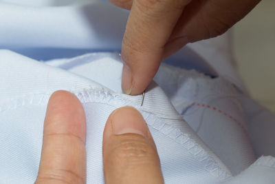 Midsection of tailor sewing textile