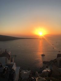 View of city at waterfront during sunset