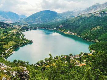 High angle view of lake amidst trees against sky