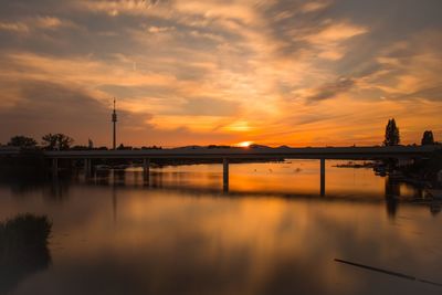 Scenic view of river against orange sky