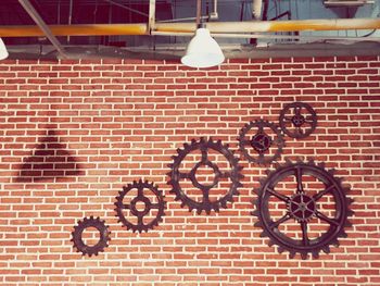 Close-up of bicycle parked against brick wall