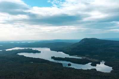 Scenic view of lake against sky during winter