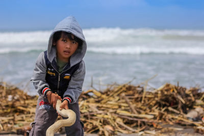 Full length of cute boy on beach