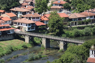 Bridge over river amidst buildings in town