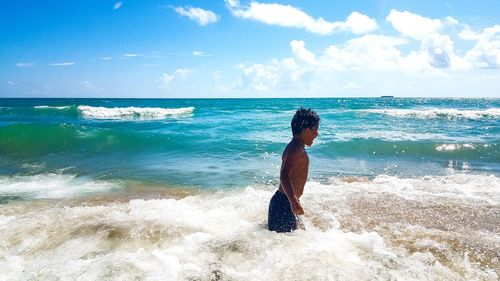 Full length of man on beach against sky