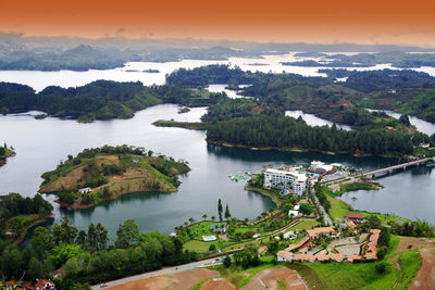 High angle view of river amidst trees against sky