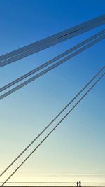 Low angle view of cables against clear sky