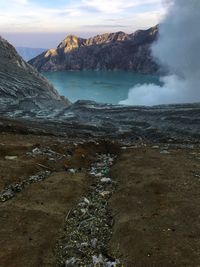 Scenic view of sea and mountains against sky