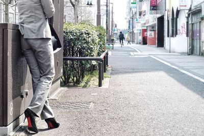 Low section of man walking in city