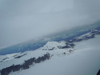 Scenic view of mountains against cloudy sky