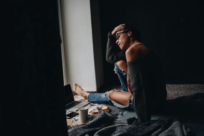 Thoughtful woman siting at home