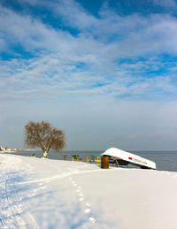 Snow covered land against sky