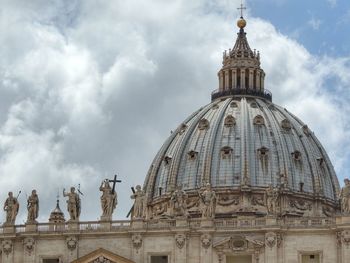 Low angle view of statue of cathedral against cloudy sky