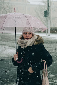 Full length of woman in snow during rainy season