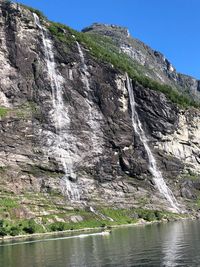 Scenic view of waterfall against sky