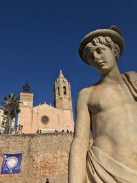 Low angle view of statue against building