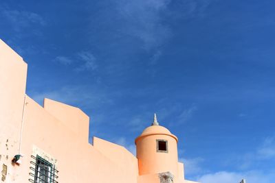 Low angle view of buildings against blue sky