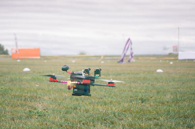 Airplane on field against sky