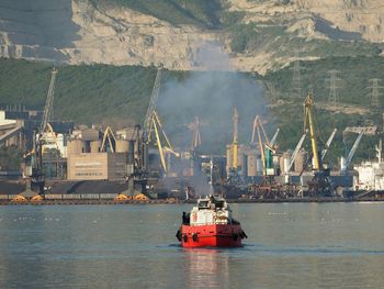 Nautical vessel on sea by mountain