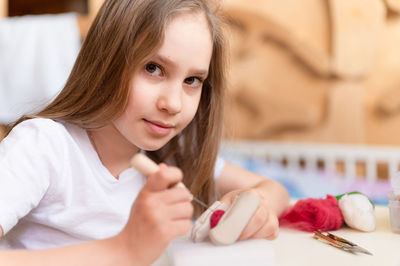 Felt wool craft handmade needle. little kid girl artisan hand makes creative toy made of sheep hair