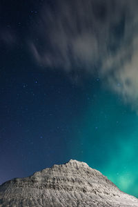 Northern lights over mountain landscape photo