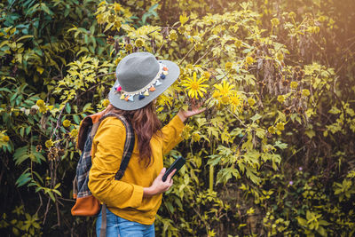 Woman standing by plants