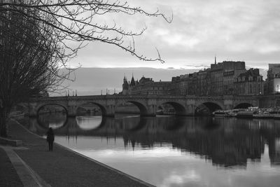 Bridge over river against cloudy sky