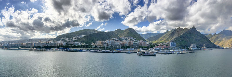 Panoramic view of sea and mountains against sky