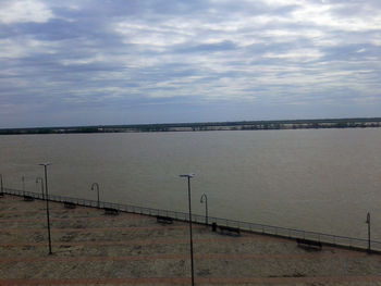 View of calm sea against cloudy sky