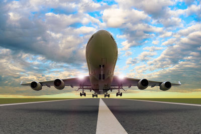 Low angle view of airplane taking off from runway against sky