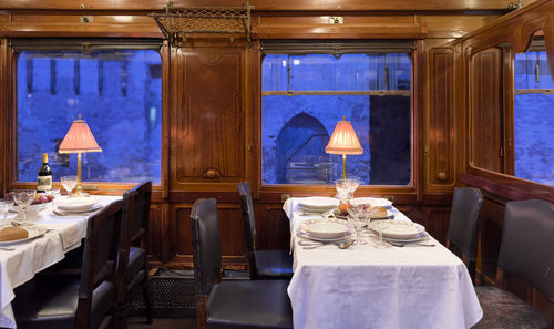 An elegant dining interior featuring a scenic evening view that creates a lovely ambiance