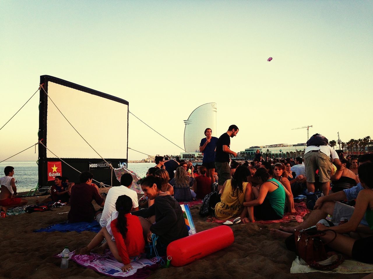 men, clear sky, large group of people, person, leisure activity, lifestyles, copy space, transportation, sky, sitting, beach, mode of transport, mixed age range, enjoyment, medium group of people, outdoors, sea, group of people, fun