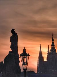Silhouette statue against sky during sunset