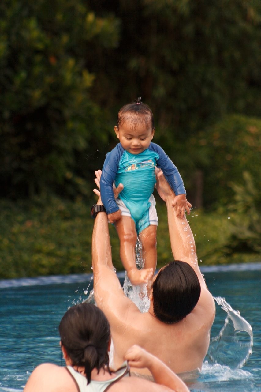 water, real people, child, childhood, togetherness, men, boys, bonding, family, leisure activity, males, two people, parent, swimming pool, pool, nature, day, lifestyles, son, positive emotion, innocence, outdoors