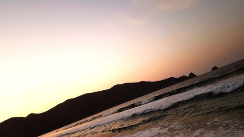 Scenic view of silhouette mountains against sky during sunset