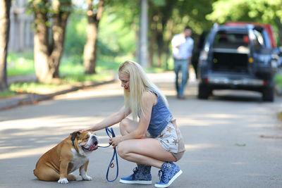 Young woman with dog on road