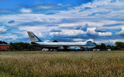 Airplane on field against sky