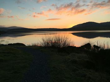 Scenic view of lake against sky during sunset