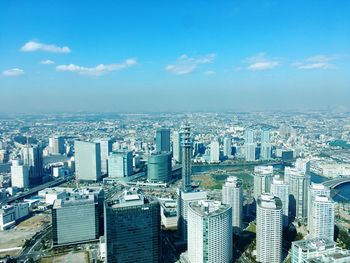 High angle view of cityscape against blue sky