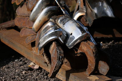 Close-up of rusty machine part on field