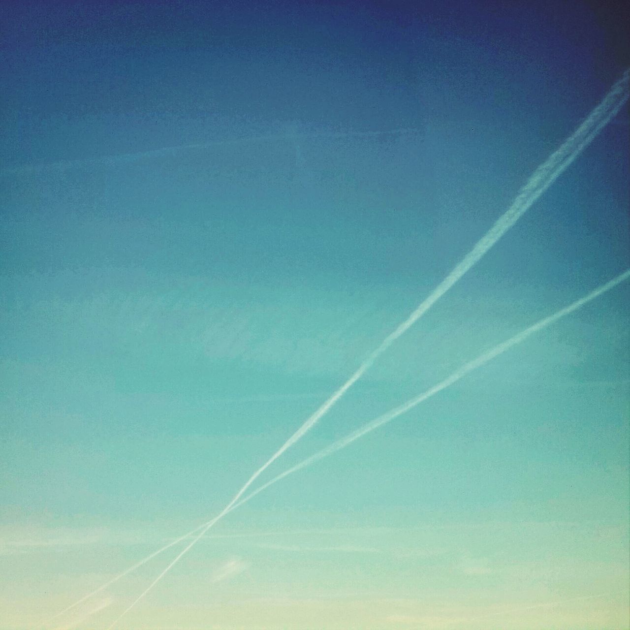 LOW ANGLE VIEW OF VAPOR TRAILS IN SKY