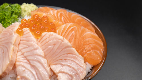 Close-up of fish on plate against black background