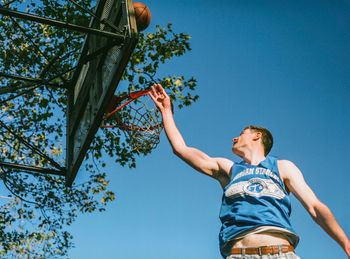 Low angle view of basketball hoop against clear sky