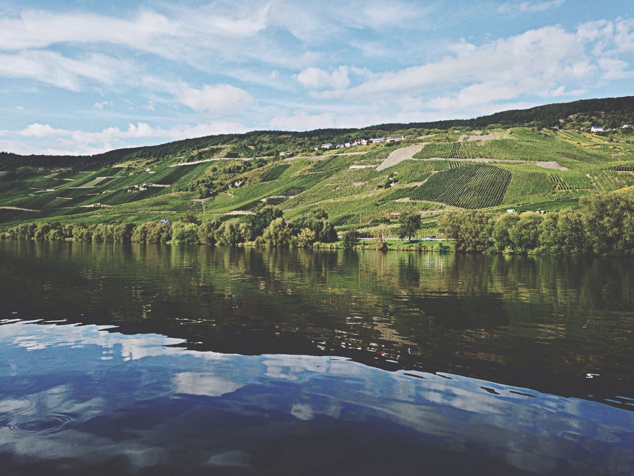 tranquil scene, tranquility, water, scenics, mountain, sky, beauty in nature, lake, nature, reflection, landscape, tree, mountain range, idyllic, cloud - sky, green color, non-urban scene, cloud, day, river