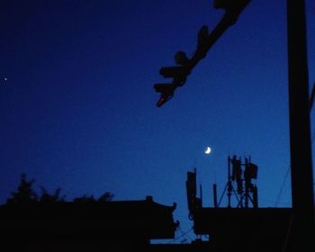 Low angle view of silhouette trees against clear sky at night